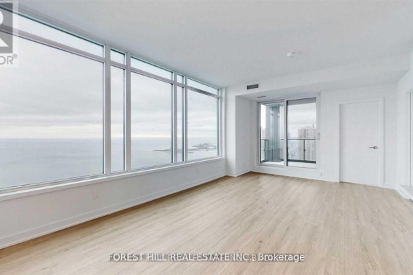Spacious living area with light wood floors and large windows overlooking the water. - 4208 - 1928 Lake Shore Boulevard W, Toronto