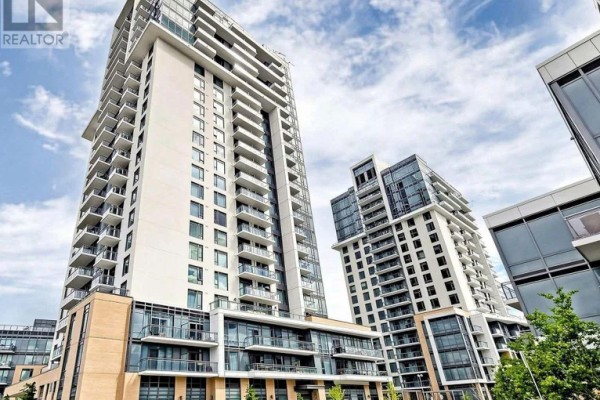 Low-angle view of a modern condo building with glass balconies and beige brick accents. - 421 - 50 Ann O'reilly Road, Toronto