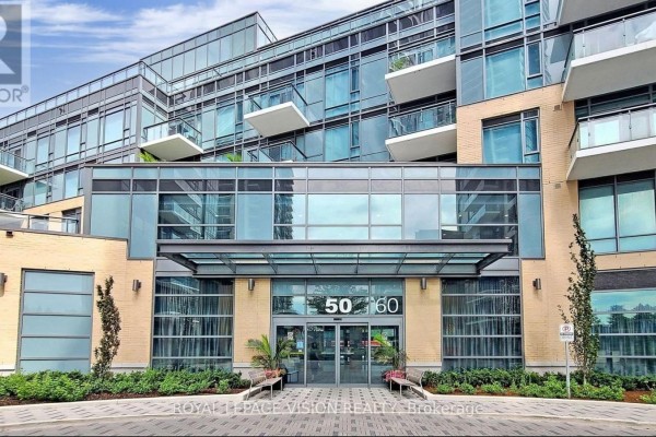 Street-level view of the condo building entrance at 50 Ann O'reilly Road with glass doors. - 421 - 50 Ann O'reilly Road, Toronto