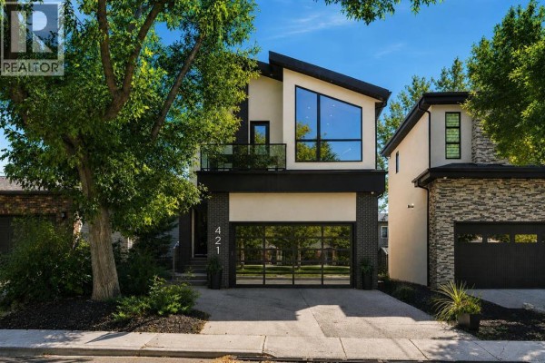 Front view of a contemporary house with dark brick and light stucco. - 421 29 Avenue Ne, Calgary