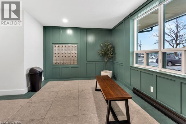 Close-up of mailboxes and wainscoting in the apartment building lobby. - 421 Fairview Drive Unit# 503, Brantford