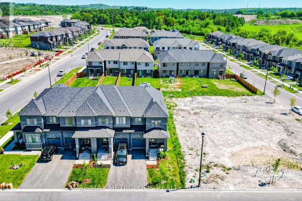 Aerial view of a townhouse development showing multiple units and surrounding construction sites. - 421 Trevor Street, Cobourg