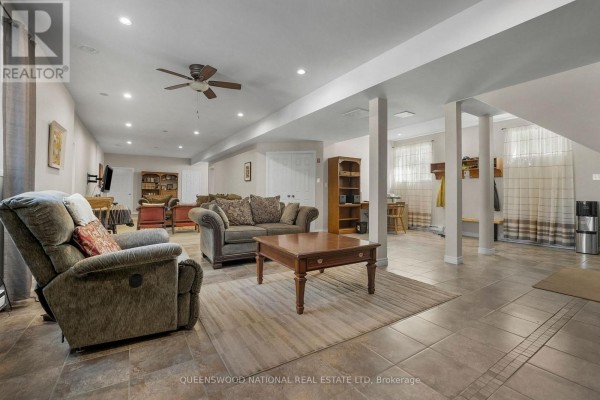 Finished basement with tile floor, recessed lighting, support beams, windows - 42125 Combermere Road Ne, Madawaska Valley