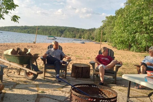 Outdoor stone patio with fire pit, sandy beach, lake access - 42125 Combermere Road Ne, Madawaska Valley