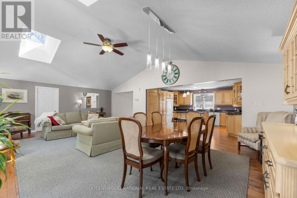 Open concept living, dining, and kitchen with vaulted ceiling, skylights, hardwood floors - 42125 Combermere Road Ne, Madawaska Valley