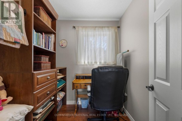 Office with hardwood floors, wooden shelving, desk, and window - 42125 Combermere Road Ne, Madawaska Valley