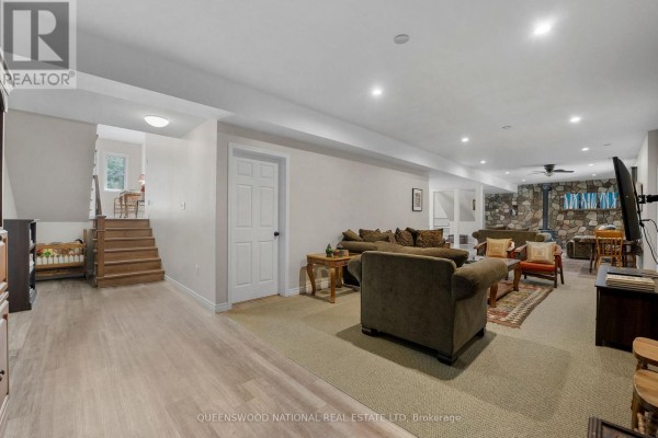 Finished basement with wood stove, stone accent wall, recessed lights - 42125 Combermere Road Ne, Madawaska Valley