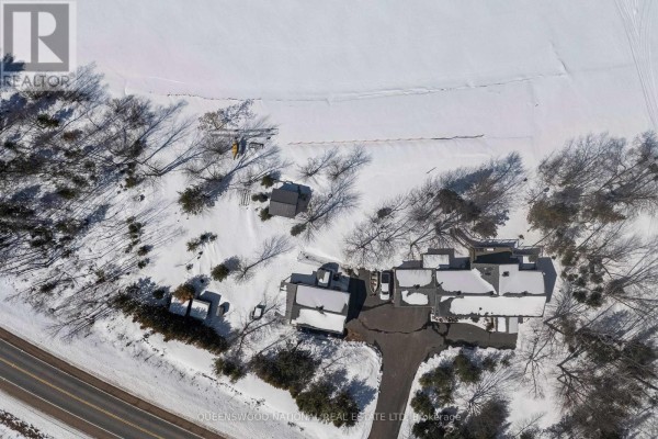 Aerial view of snow-covered waterfront property with house, garage, dock - 42125 Combermere Road Ne, Madawaska Valley