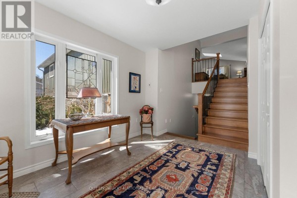 Entryway with bay window, tile floor, and hardwood stairs - 42125 Combermere Road Ne, Madawaska Valley