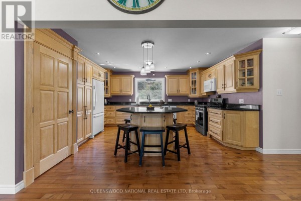 Kitchen with light wood cabinets, granite counters, island, hardwood floors - 42125 Combermere Road Ne, Madawaska Valley