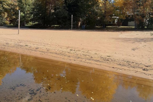 Sandy beach with volleyball poles and clear water - 42125 Combermere Road Ne, Madawaska Valley