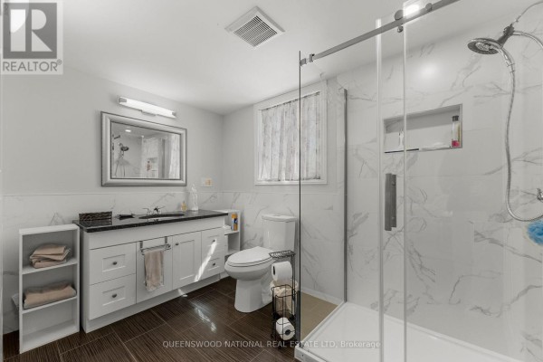 Modern bathroom with vanity, glass shower, tiled walls - 42125 Combermere Road Ne, Madawaska Valley