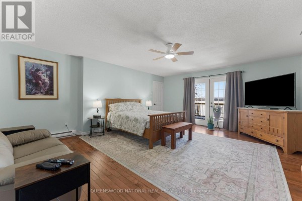 Bedroom with hardwood floors, French doors, and ceiling fan - 42125 Combermere Road Ne, Madawaska Valley