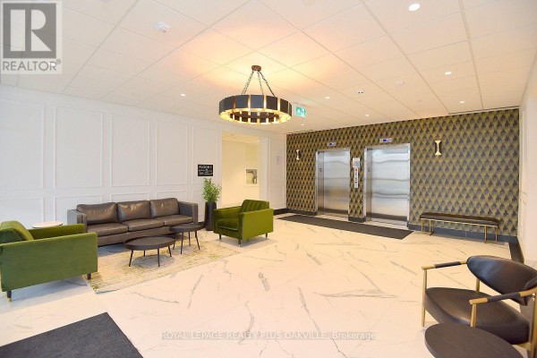 Apartment building lobby with marble tile floor, elevators, green velvet chairs, and sofa. - 422 - 1936 Rymal Road E, Hamilton