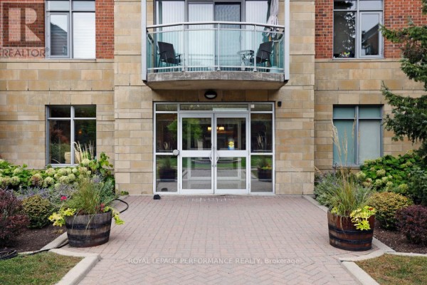 Building entrance with double glass doors and stone facade. - 422 - 205 Bolton Street, Ottawa