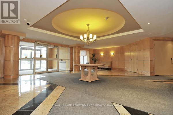Building lobby with patterned floors, circular ceiling feature, and furniture. - 422 - 205 Bolton Street, Ottawa