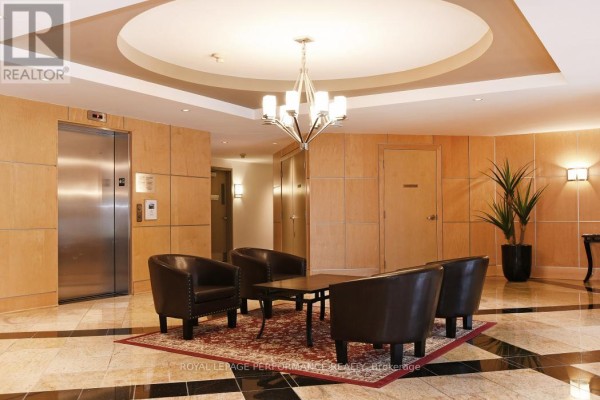 Lobby seating area and elevator with wood paneling and marble floors. - 422 - 205 Bolton Street, Ottawa