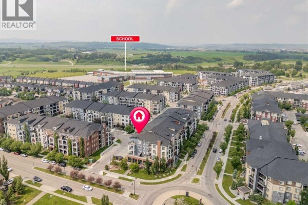 Aerial view of a Calgary residential complex, showing proximity to a school. - 4220, 215 Legacy Boulevard Se, Calgary