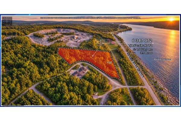 Sunset aerial view of a wooded lot bordered by the Gatineau River, with a new home foundation visible. - 423 Ch. De La Rivière, Chelsea