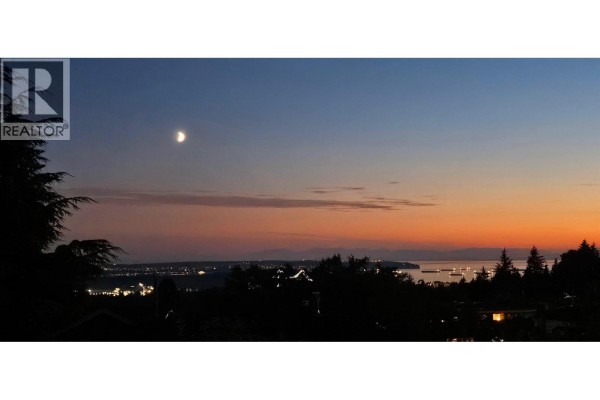 Twilight sky over a silhouetted landscape with a crescent moon visible. - 4243 Delbrook Avenue, North Vancouver