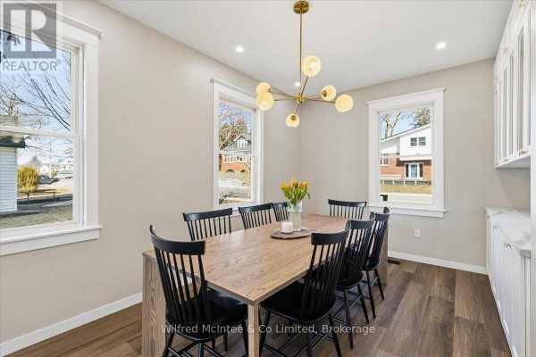 Renovated dining room with modern chandelier, built-in cabinets, wood floors - 425 Yonge Street S, Brockton