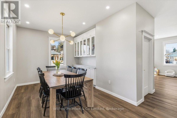 Renovated dining room with modern chandelier, built-in buffet, and wood-look floors - 425 Yonge Street S, Brockton