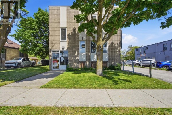 Front entrance of commercial building with glass door and green lawn. - 426 Third Street, London East