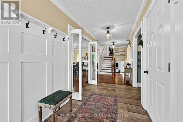 Bathroom with granite countertop vanity, wood-framed mirror, and glass-enclosed shower. - 426 Zephyr Road, Uxbridge