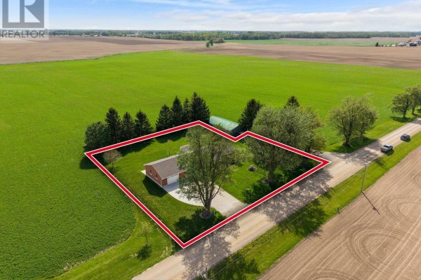 Aerial view of a brick home with a red boundary line on a large property. - 42633 Moncrieff Road, Morris Turnberry
