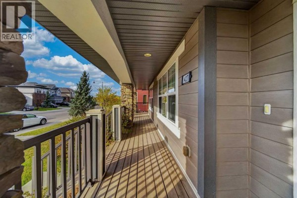 View from the covered front porch looking towards the street and neighboring houses. - 427 Mahogany Boulevard Se, Calgary