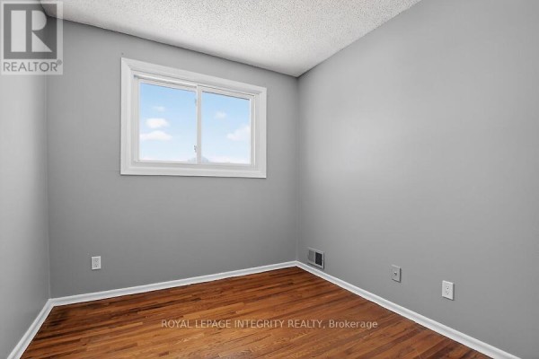 Bright kitchen with white cabinets, stainless steel appliances, and tiled backsplash - 427 Moodie Drive, Ottawa