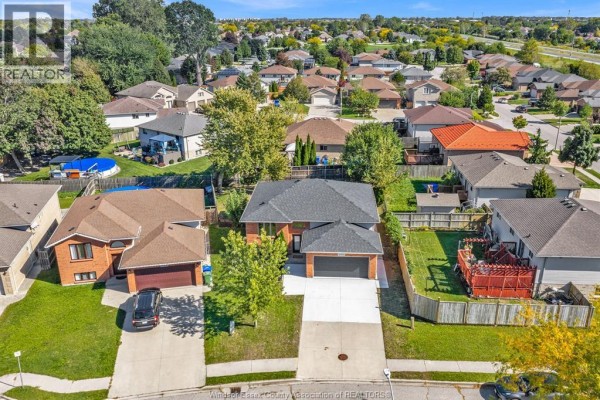 Aerial view of a suburban neighborhood with multiple single-family homes and well-maintained yards. - 4274 Dennison Court, Windsor