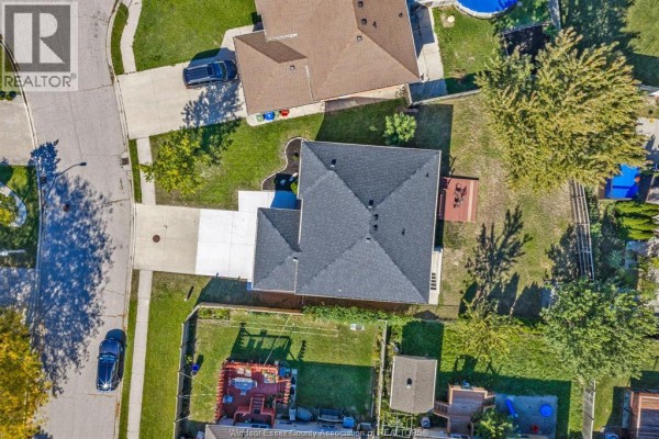 Overhead aerial view of a residential property showing the house, driveway, and backyard. - 4274 Dennison Court, Windsor