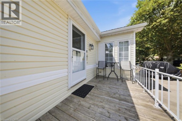Close-up of mobile home entrance with snow-covered surroundings - 428 Pine Pass, Wellington