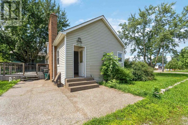 Two-door garage with gray siding and white garage doors. - 4284 Fly Road, Lincoln