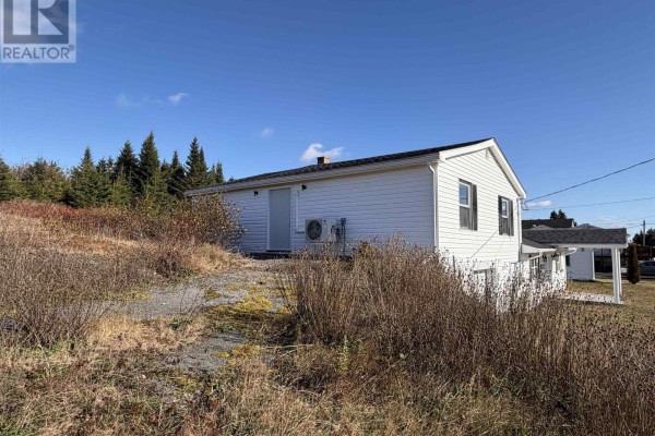 Close-up of the house showing garage door and entrance - 429 Highway 7, Ecum Secum