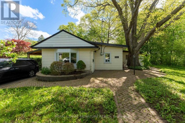 Kitchen with wood cabinets, stainless steel appliances, and tile flooring. - 429 Rouge Hills Drive, Toronto