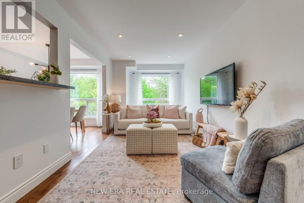 Backyard patio with a sectional sofa, coffee table, dining set, and covered gazebo. - 43 - 7284 Bellshire Gate, Mississauga