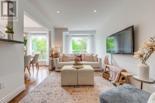 Basement wet bar with a sink, mini-fridge, white cabinetry, and a desk area. - 43 - 7284 Bellshire Gate, Mississauga