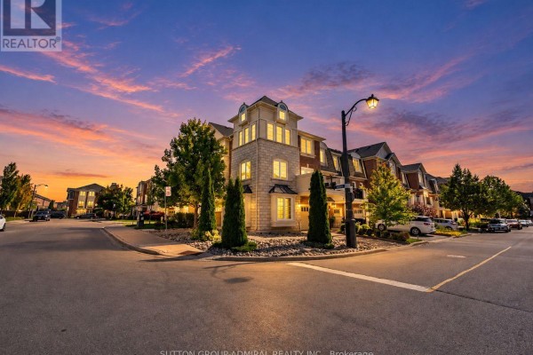 Street view of a townhouse complex at sunset with dramatic lighting. - 43 Deans Drive, Toronto
