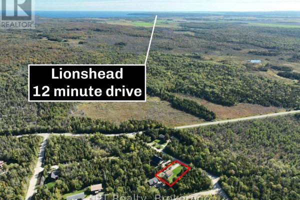 Aerial view of Northern Bruce Peninsula landscape with homes, forest, and marked route to Lionshead 12 minute drive. - 43 Henwood Street, Northern Bruce Peninsula
