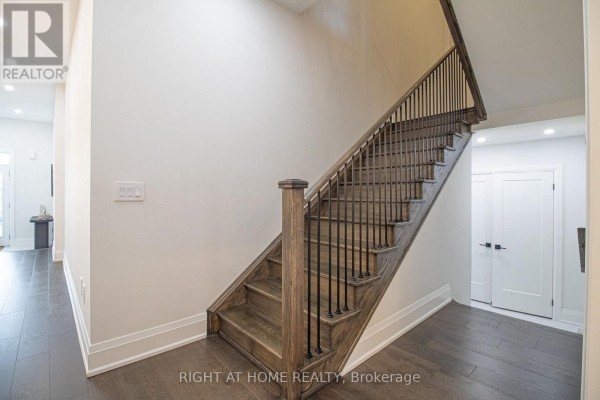 Spacious living room with dark hardwood floors, recessed lighting, and large windows. - 43 Longworth Avenue, Richmond Hill