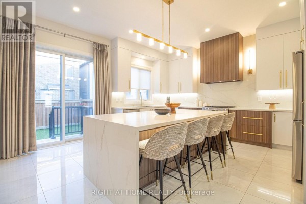 Formal dining room with a large wooden table, upholstered chairs, and chandelier. - 43 Longworth Avenue, Richmond Hill
