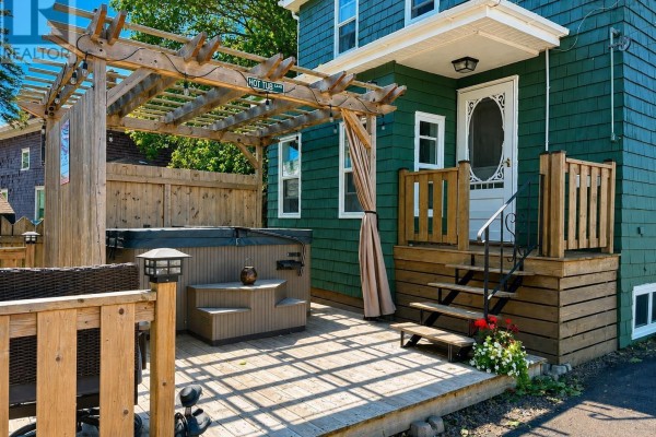 Wooden deck with hot tub and pergola next to the entrance of the duplex. - 43 Queen Street, Amherst
