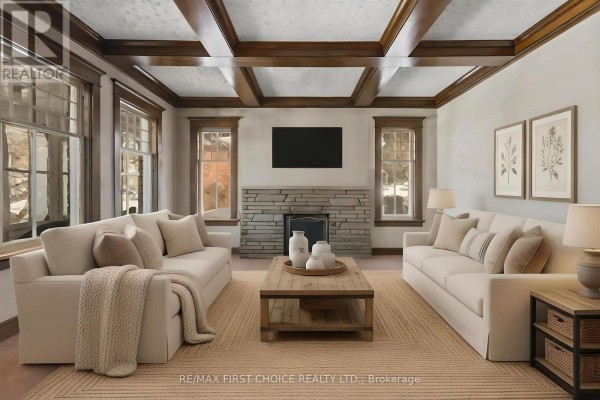 Living room with a stone fireplace, coffered wood ceiling, and two sofas. - 43 Summit Avenue, Thunder Bay