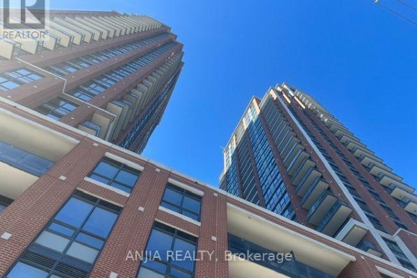 Low angle view of brick condo towers against a clear blue sky. - 430 - 3270 Sheppard Avenue E, Toronto
