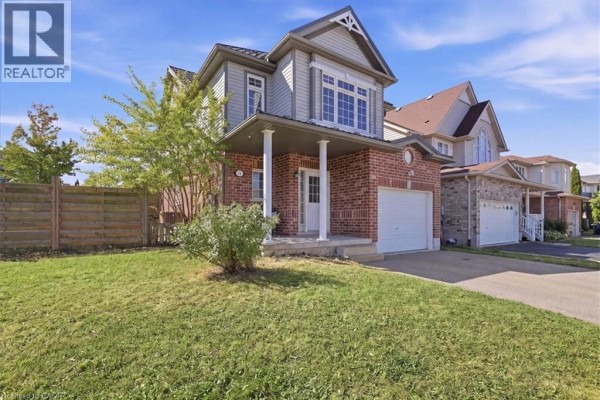 Front exterior view of a two-story house with a lawn and driveway. - 430 Mountain Laurel Crescent, Kitchener