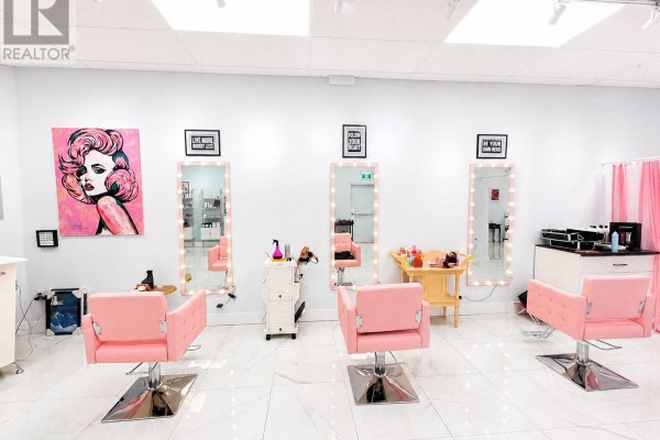 Retail area with shelves of products, a glass table, and pastel wall. - 430 Topsail Road Unit#77, St  John S