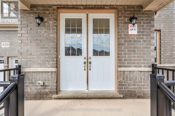Interior view of an entryway with white double doors, tiled floor, white walls, and a window. - 430 Vandusen Avenue, Southgate