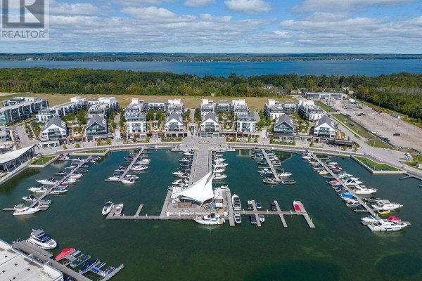 Aerial view of the marina at Friday Harbour, featuring many docked boats. - 431 - 415 Sea Ray Avenue, Innisfil